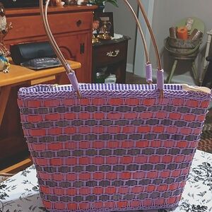 Purple & red weaved hand bag. Gold handles & purple striped CLEAN fabric inside.